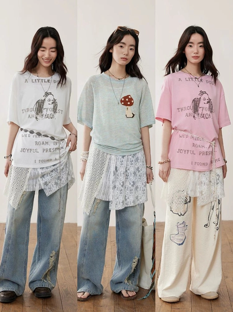 Layered asymmetric crochet lace camisole styling with casual slogan tees, lace textures, and relaxed printed streetwear trousers