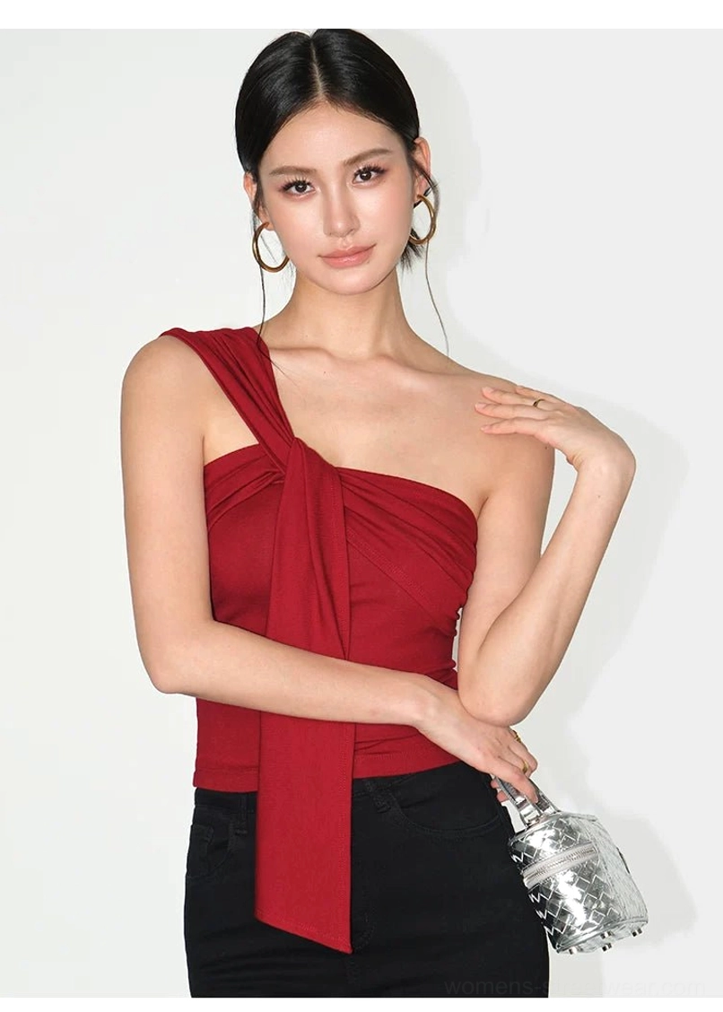 Asymmetric draped one-shoulder crop top with sculptural neckline and statement shoulder sash