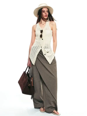 Brown gray asymmetric draped wrap wide-leg streetwear pants styled with a crochet halter vest in a white studio