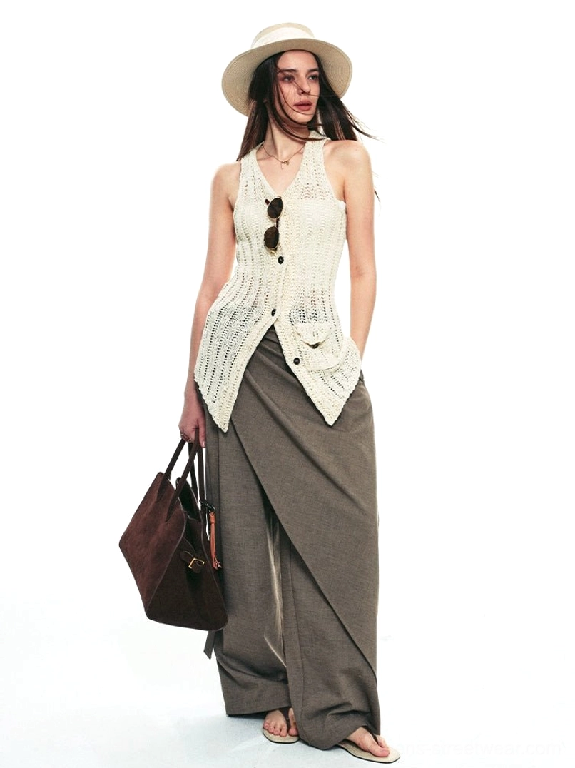 Brown gray asymmetric draped wrap wide-leg streetwear pants styled with a crochet halter vest in a white studio