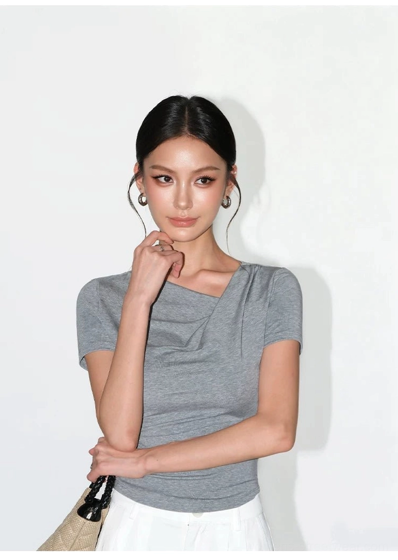 Asymmetric off-shoulder ruched slim fit top showing gathered body-contouring construction