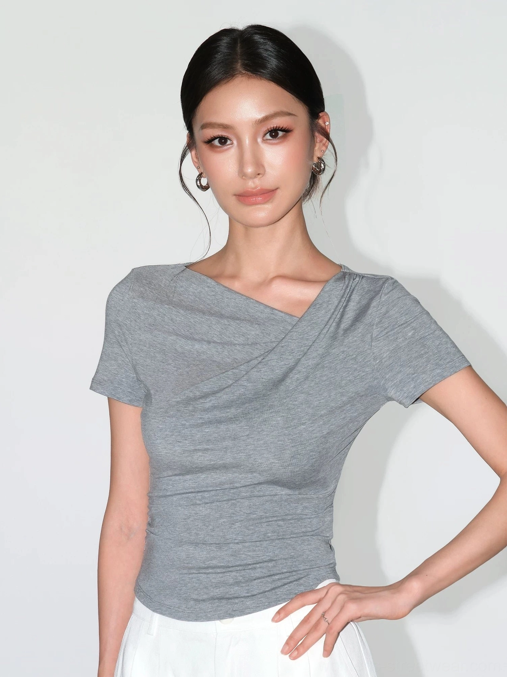 Heather gray asymmetric ruched slim fit top with short sleeves and sculpted waist silhouette