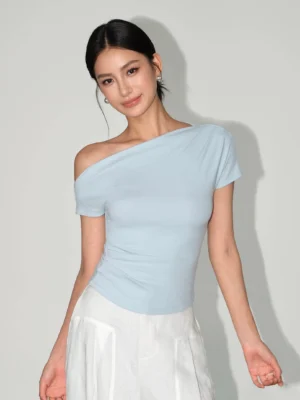 Light blue asymmetric one-shoulder slim-fit tee styled with white wide-leg pants for a modern Korean streetwear outfit