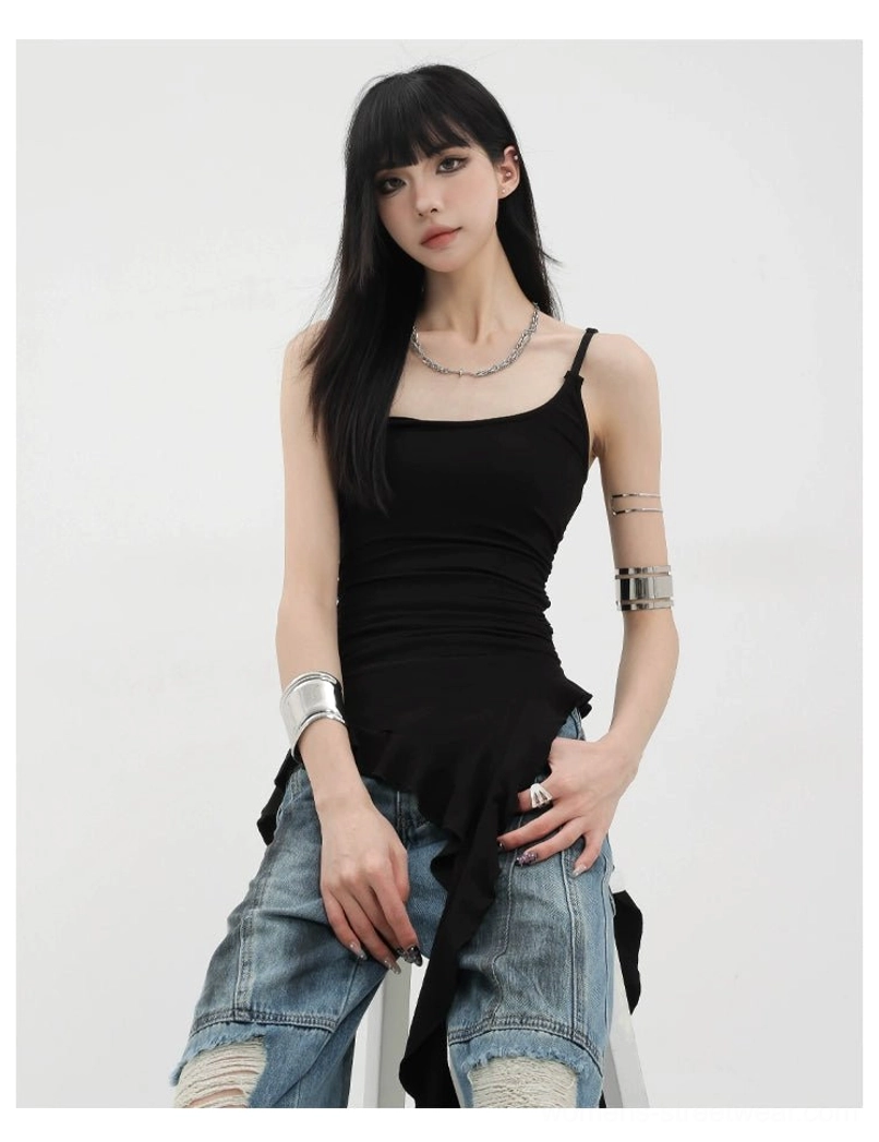 Front half-body seated close-up view of asymmetric ruffle tank with u-neck ribbon straps and layered necklace silver jewelry styling