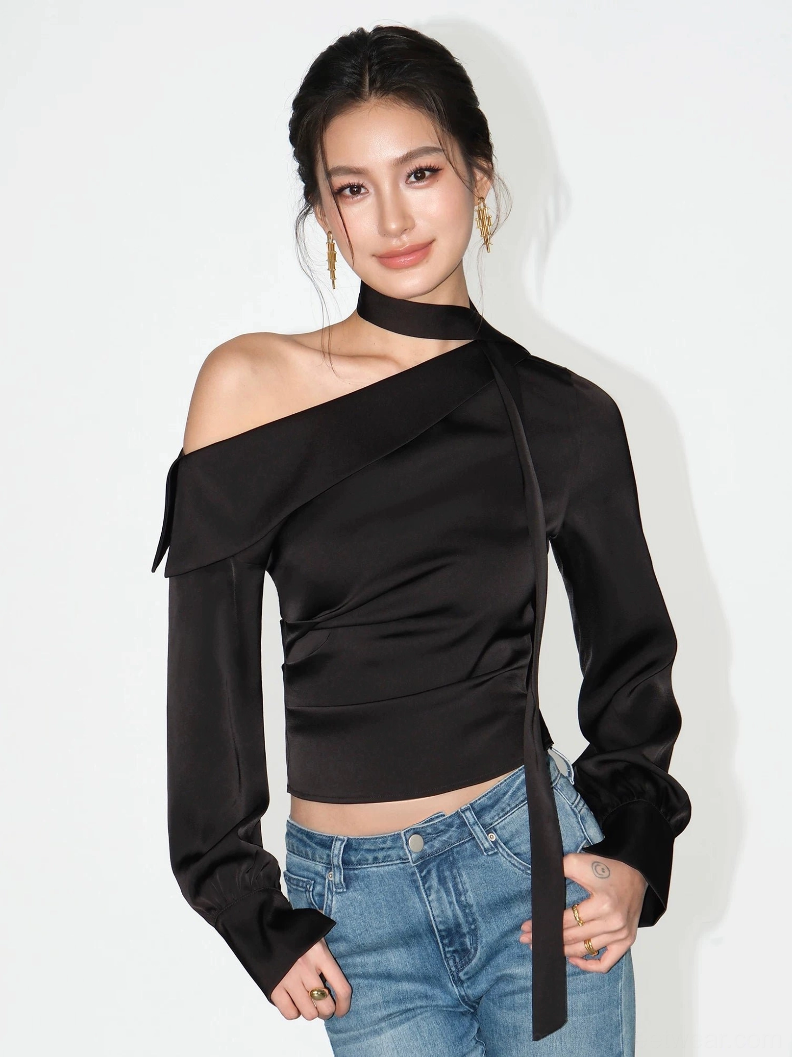 Black asymmetric satin choker blouse with one shoulder neckline and ruched waist styled with blue jeans