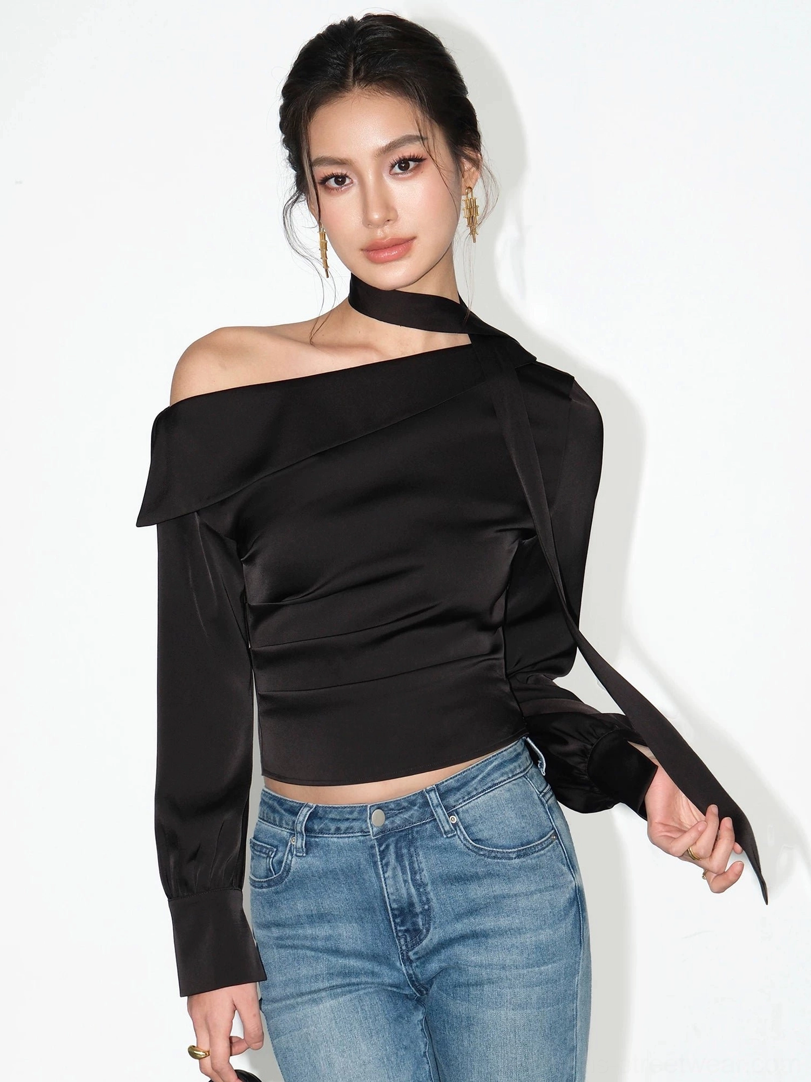 Side view of black one-shoulder satin choker blouse with long trailing neck scarf and asymmetric sleeves