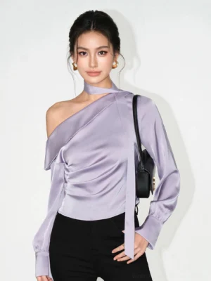 Grayish purple asymmetric satin choker blouse with ruched waist styled with black trousers and mini shoulder bag