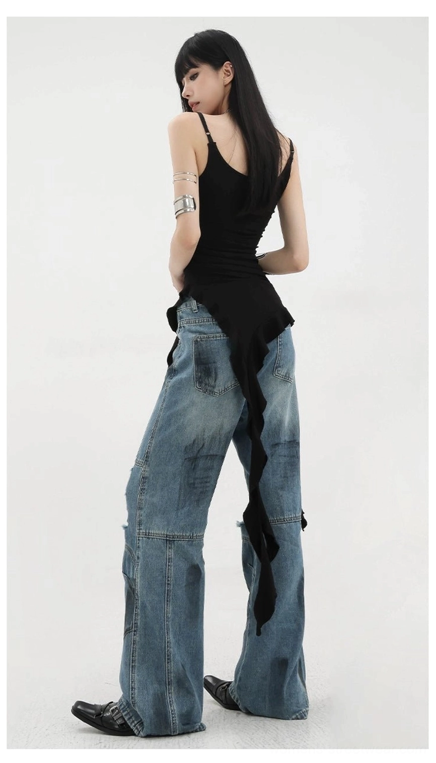 Back full-body view of asymmetric ribbon ruffle tank top with minimalist back design thin spaghetti straps and ripped denim styling