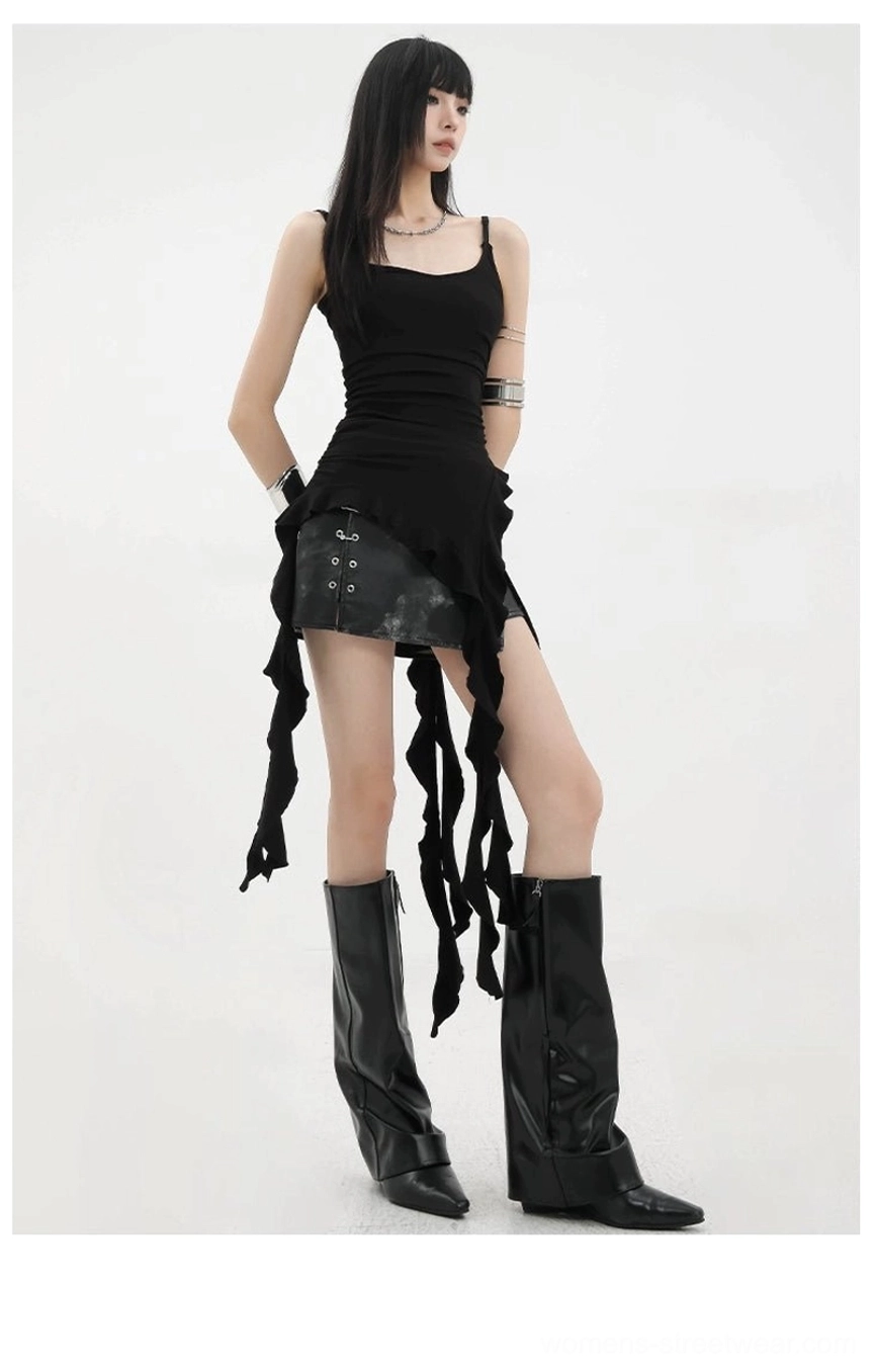 Asymmetric ruffle tank top paired with oversized leather jacket showing advanced layering techniques and editorial styling approach