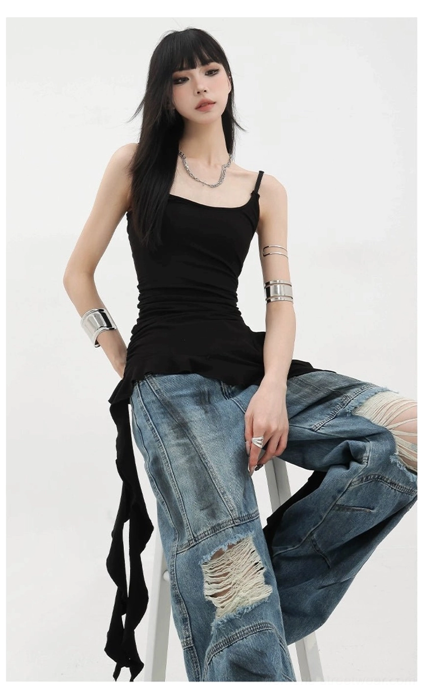 Texture close-up of ruffled trim and ribbon detail on asymmetric tank top demonstrating design precision and fabric construction quality