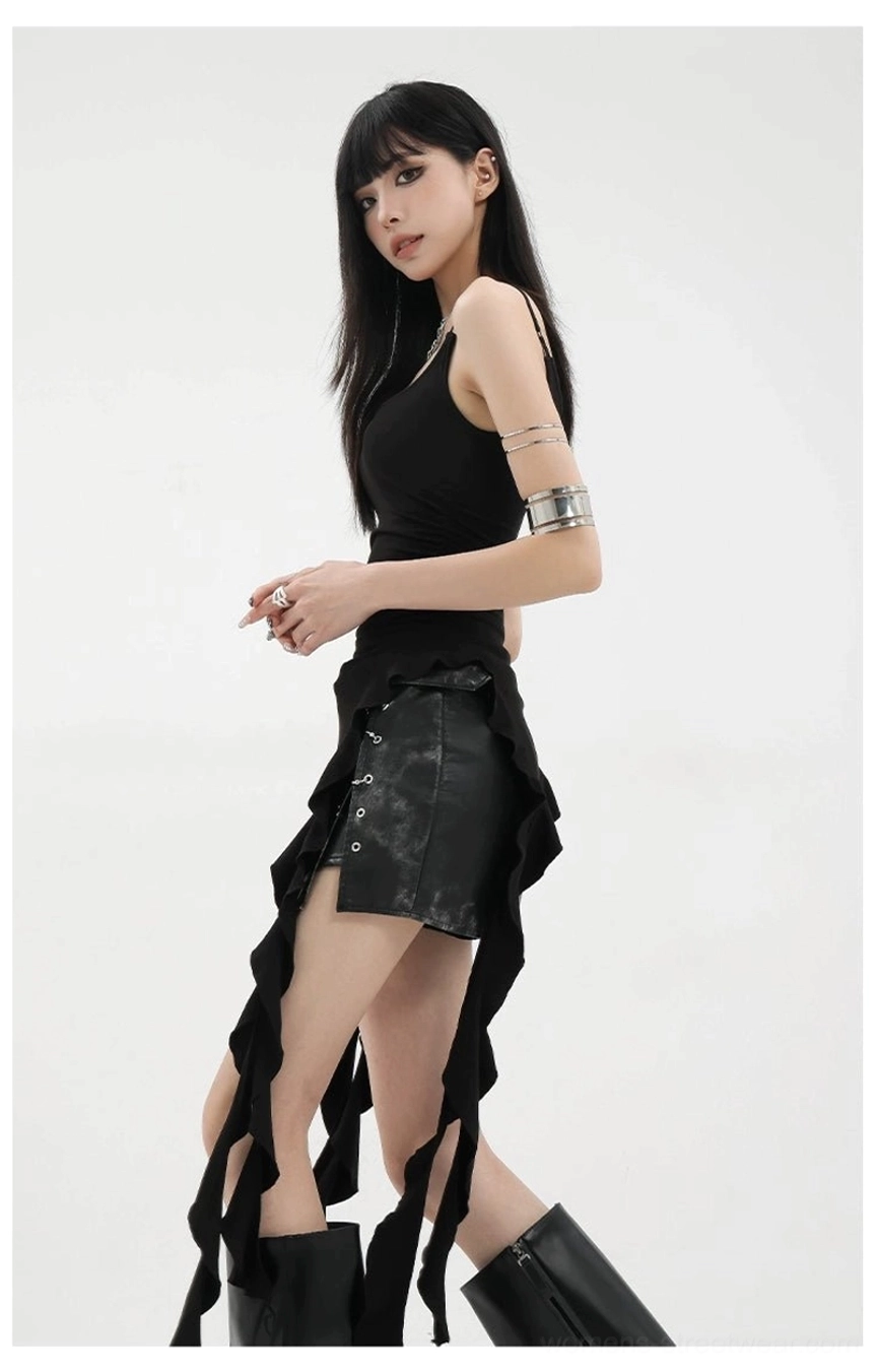 Detail shot of asymmetric tank top thin spaghetti straps and shoulder construction on model showing strap precision and fit
