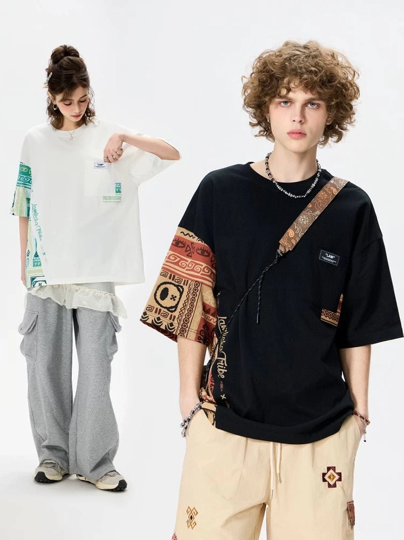 Black and white asymmetric tribal panel oversized cotton T-shirts styled with wide-leg pants in a streetwear studio look