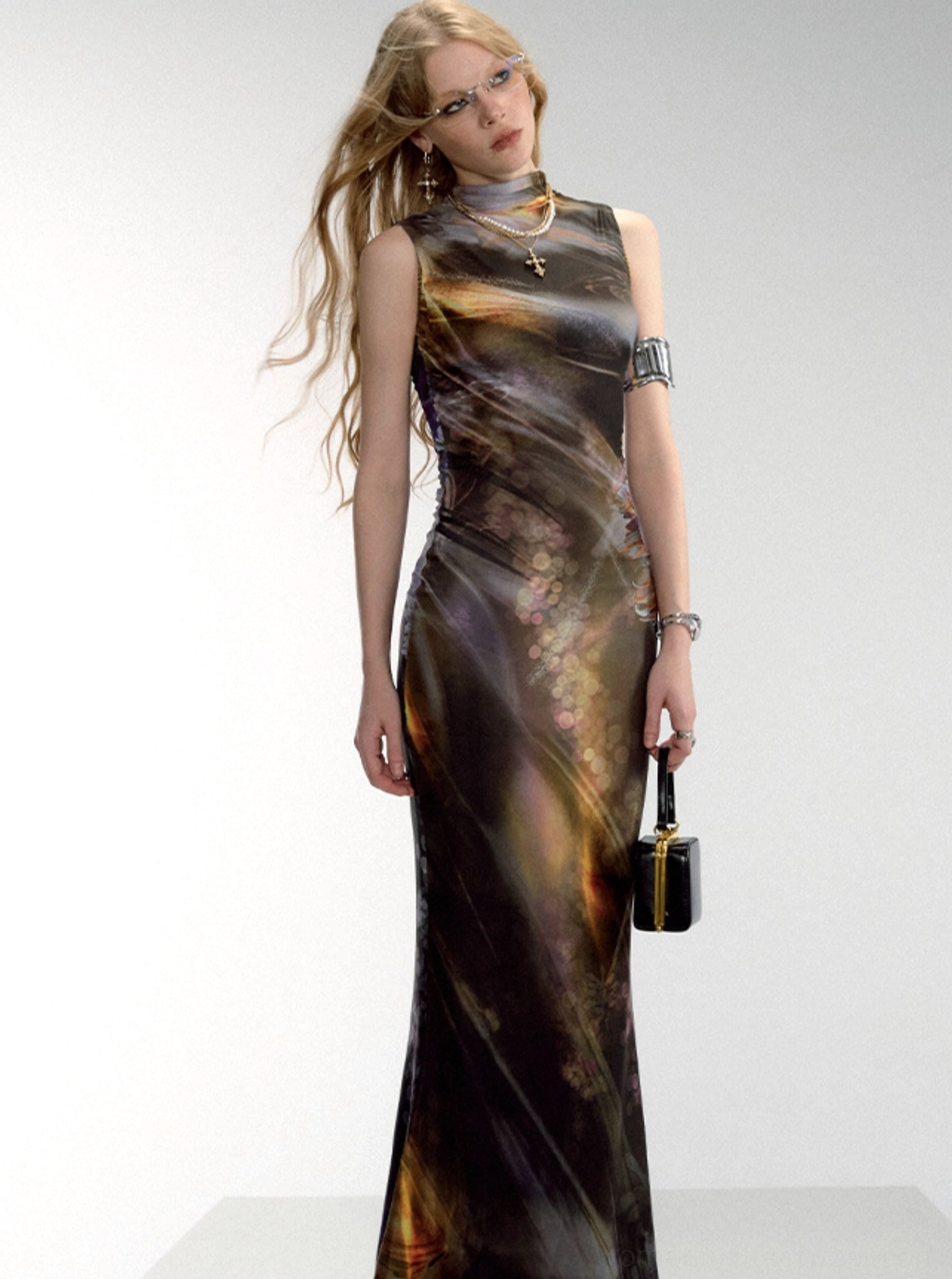 Aurora print mock neck fishtail maxi dress shown from the side with a fitted sleeveless silhouette