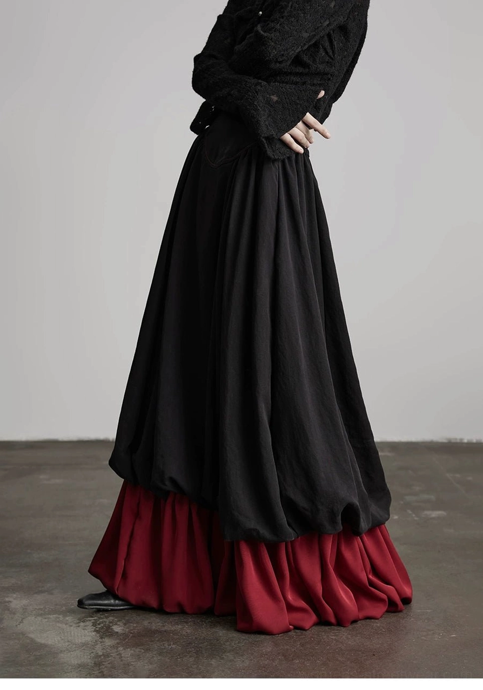Avant-garde black faux layered A-line maxi skirt with wine red contrast panel styling