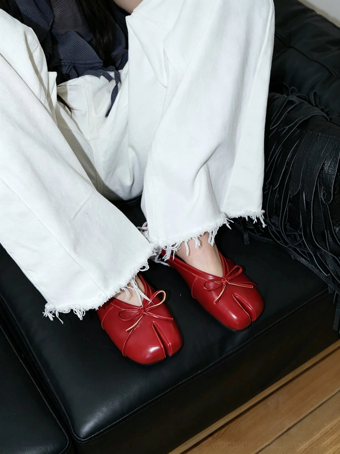 Contemporary split toe bow mules styled as an avant-garde flat shoe for everyday fashion