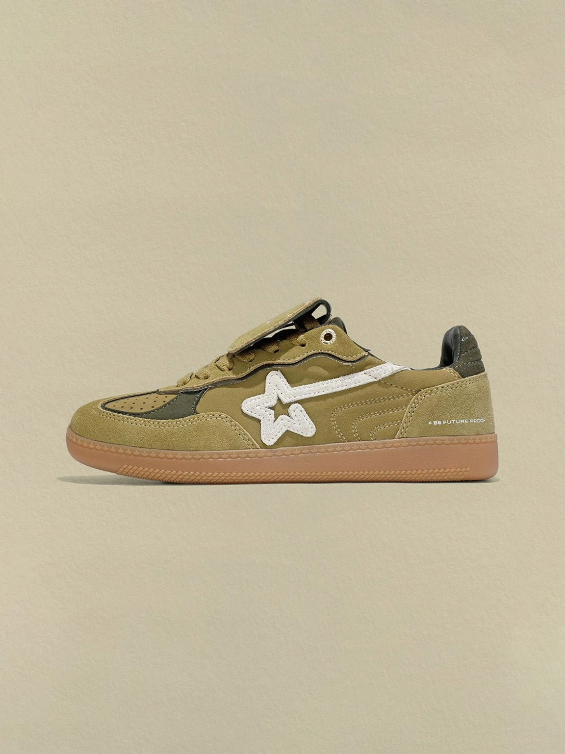 Avocado suede retro sneakers featuring a white star overlay, hook-and-loop tongue strap, dark green heel, and gum sole