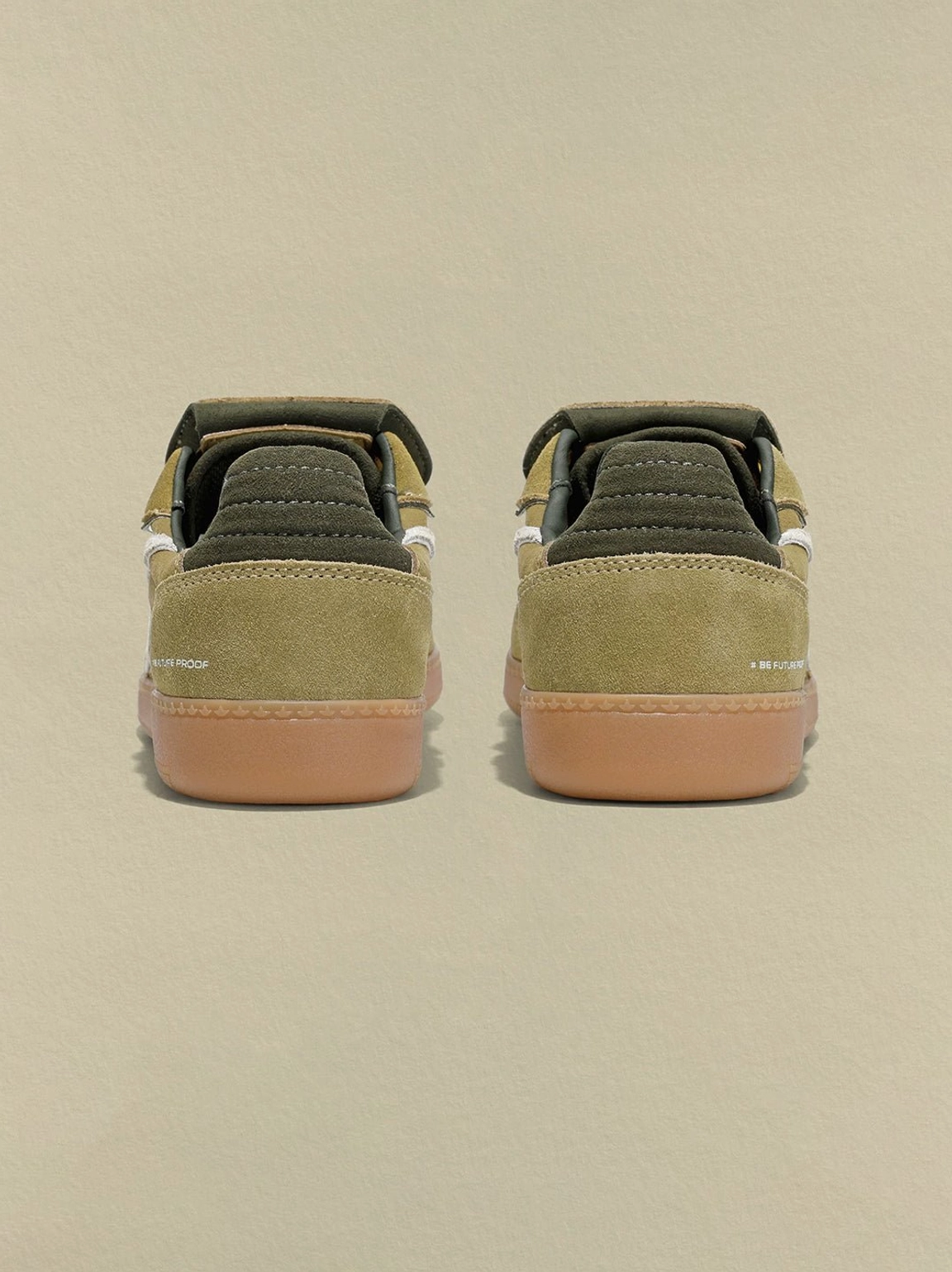 Rear view of avocado suede retro trainers with dark green heel panels and gum rubber soles