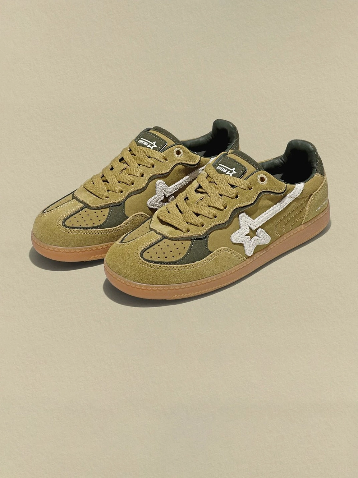 Avocado suede star-panel retro sneakers with a low profile, tonal olive panels, and gum rubber sole