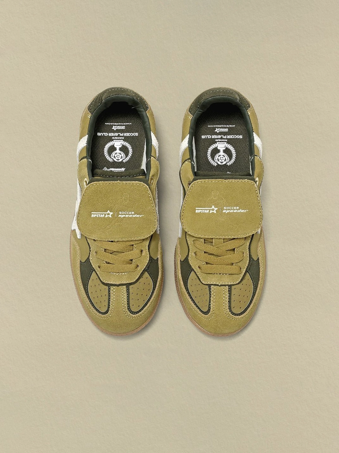 Top view of avocado suede star-panel sneakers with branded insoles, printed tongue straps, and tonal laces
