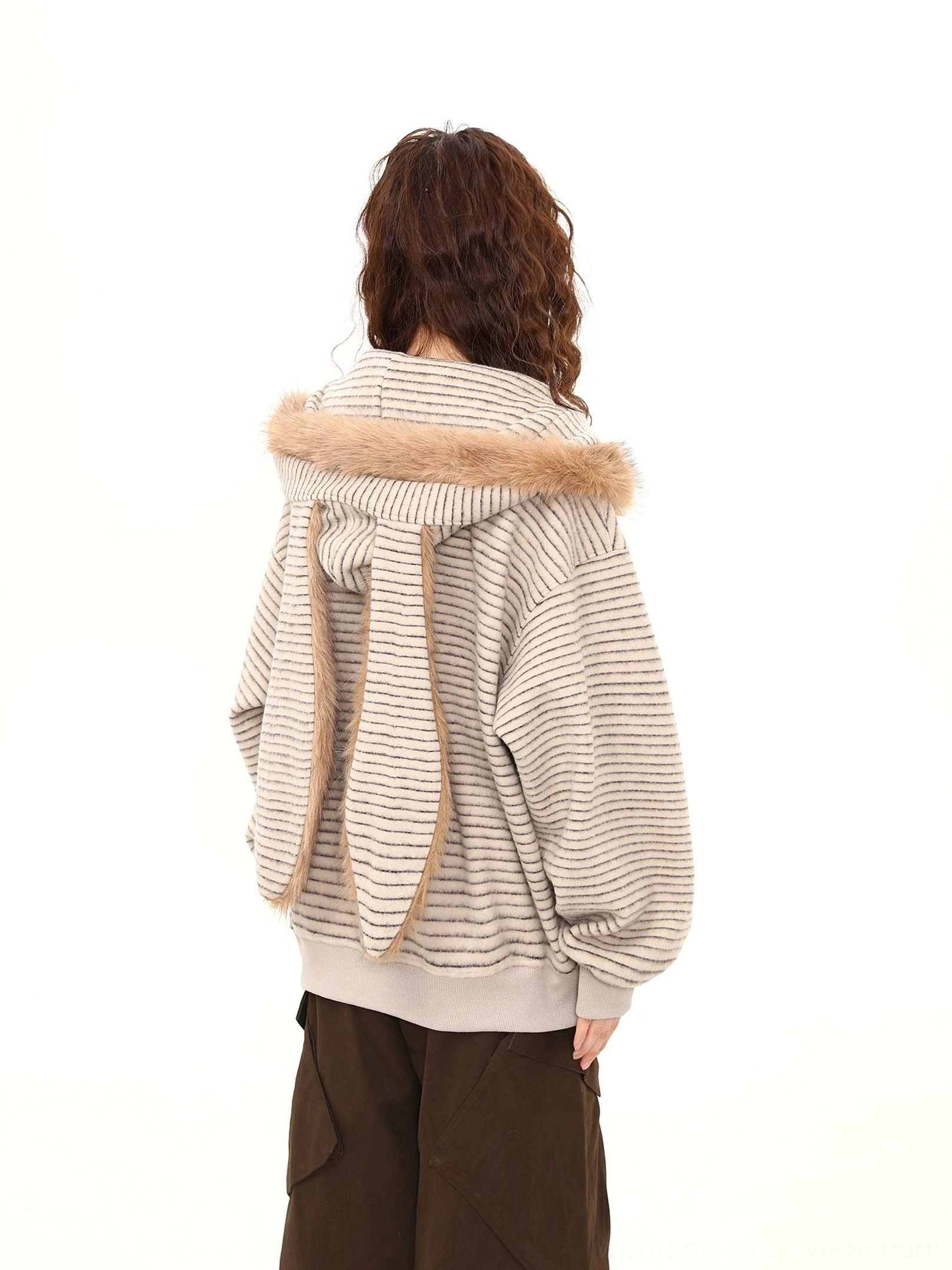 Back view of a striped oversized bunny-ear hoodie showing the long bunny ears attached to the plush hood