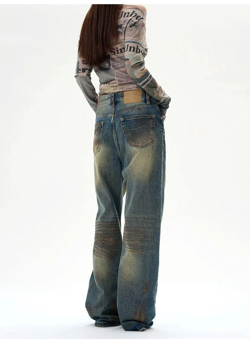 Baggy blue distressed jeans with relaxed proportions, classic denim construction, and contemporary street fashion appeal