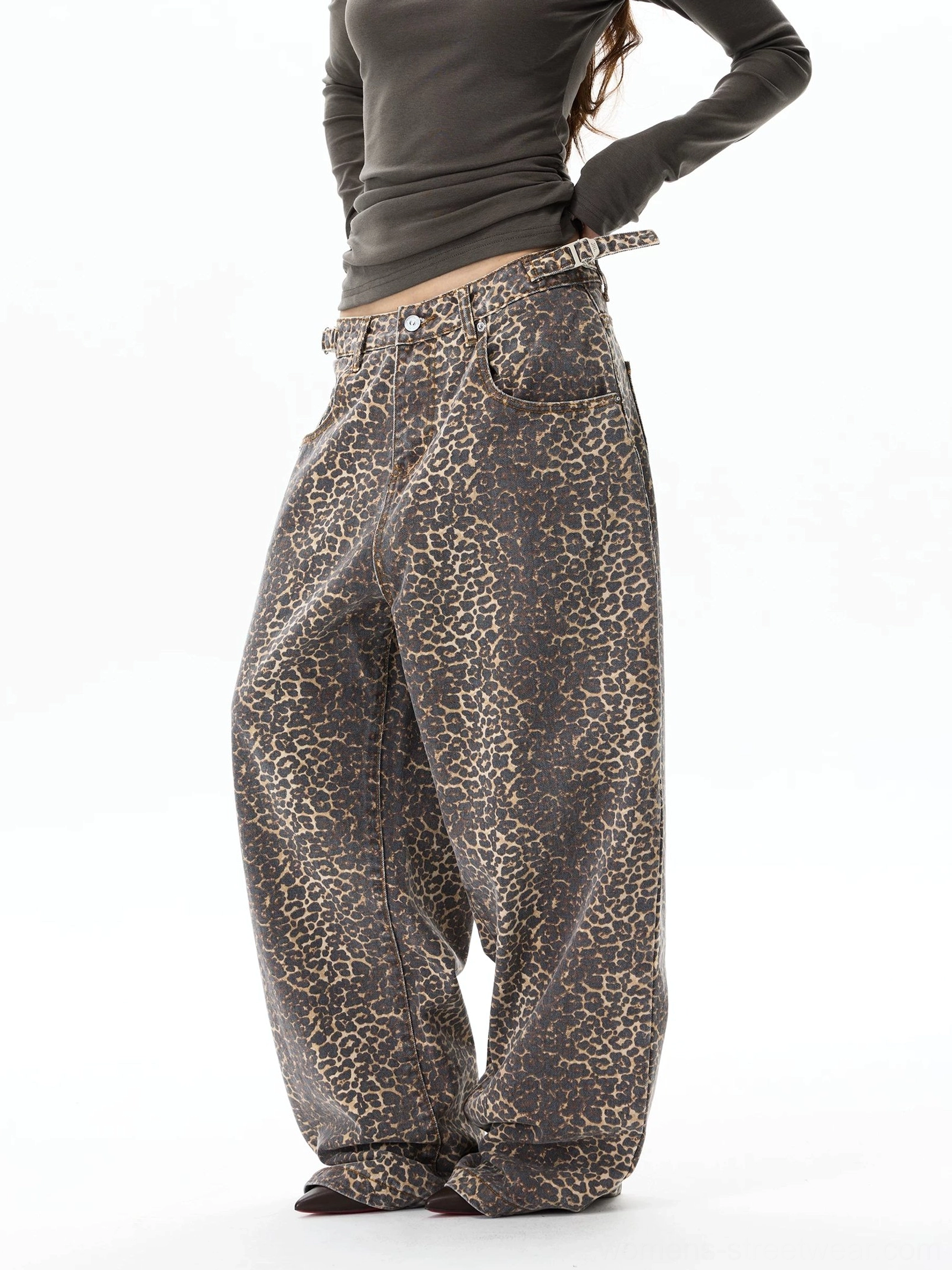 Side three-quarter view of baggy leopard print denim jeans with low-rise waist, front pocket, and dramatic wide legs