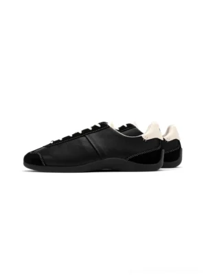 Black ballet-inspired slim leather-look streetwear trainers in flat side overhead studio product view