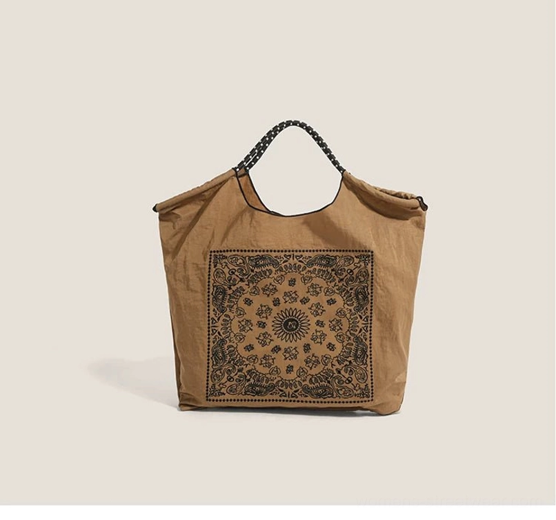 Brown bandana paisley drawstring market tote bag with contrast dotted shoulder straps front view