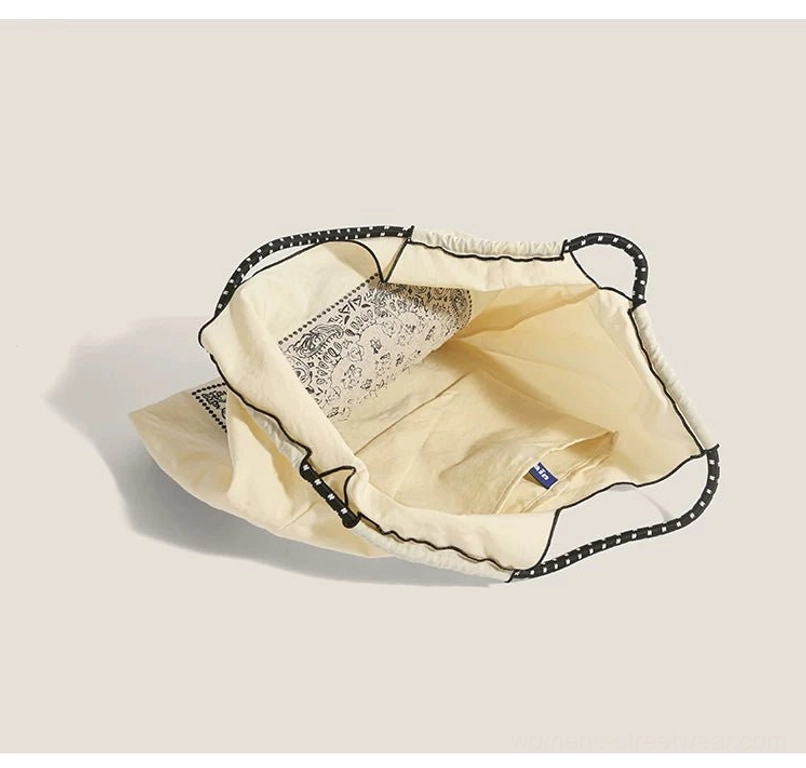 Interior view of off white drawstring streetwear market tote bag with spacious lined main compartment