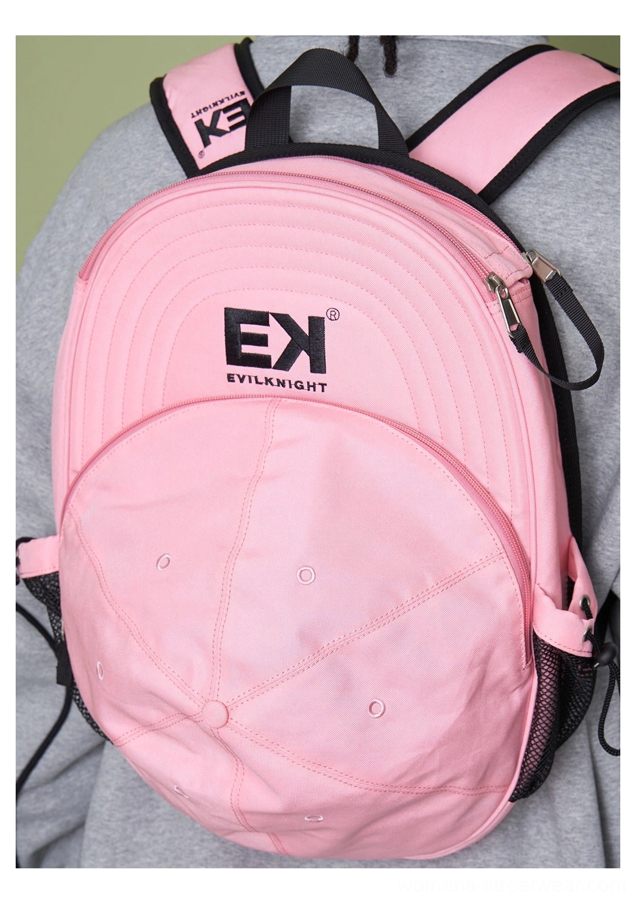 Pink baseball cap silhouette streetwear backpack worn from overhead rear view with adjustable pink shoulder straps