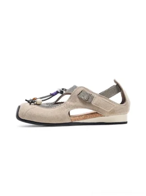 Taupe beaded T-strap cork footbed streetwear ballet sandal shown in left side profile on a white studio background