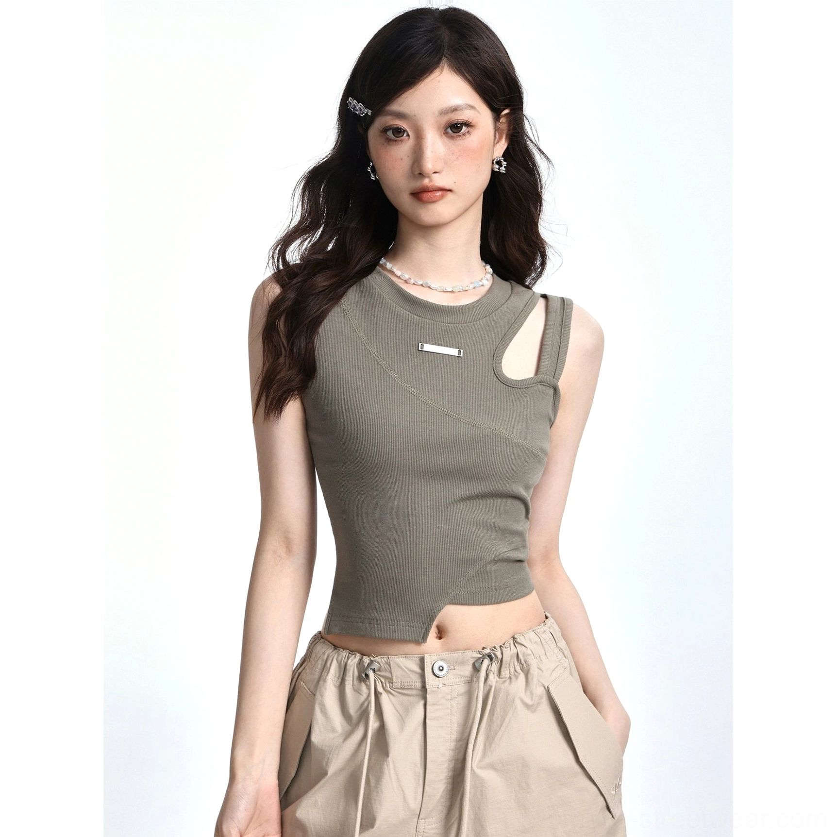 Bean Paste Green sleeveless asymmetric cutout crop tank with ribbed texture and metal chest detail styled in Korean Acubi streetwear look