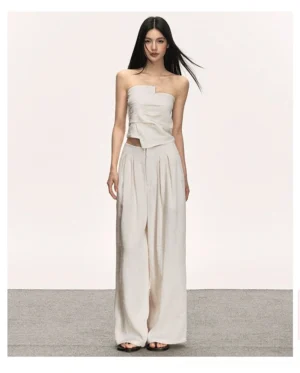 Beige asymmetric strapless top and high-waisted wide-leg pants summer two-piece outfit front view