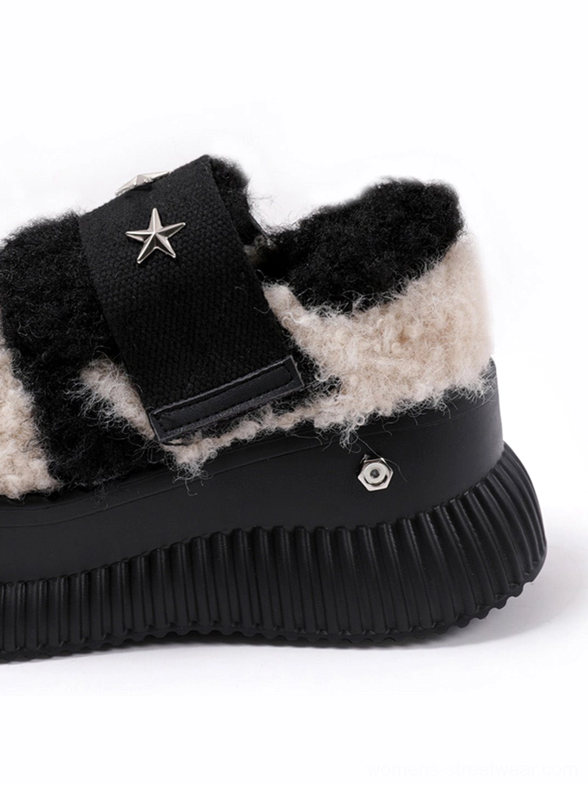 Close-up side detail of beige and black fuzzy Y2K sneakers with silver star strap hardware, metal accents, and thick ridged platform soles