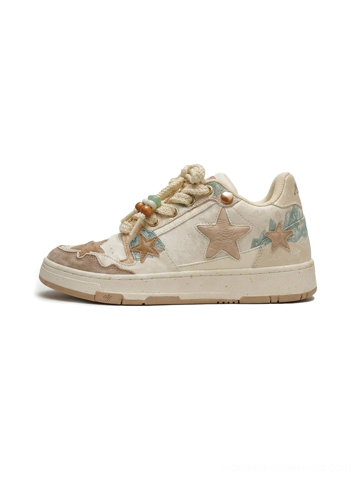 Beige and brown jacquard star panel retro court sneakers shown in side profile with teal embroidery and decorative rope laces