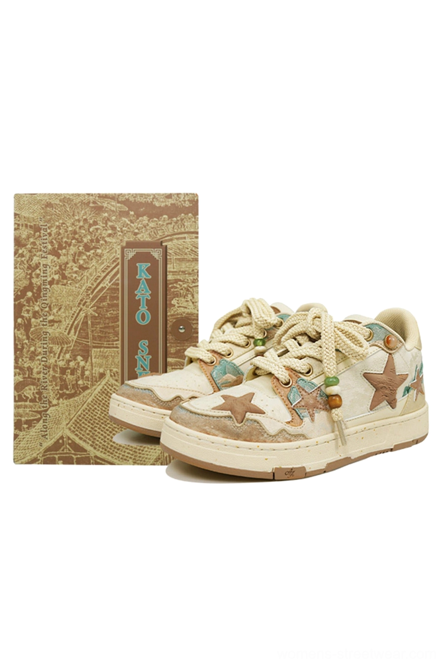 Flat lay of beige and brown jacquard star panel sneakers with embroidered details and traditional vintage card