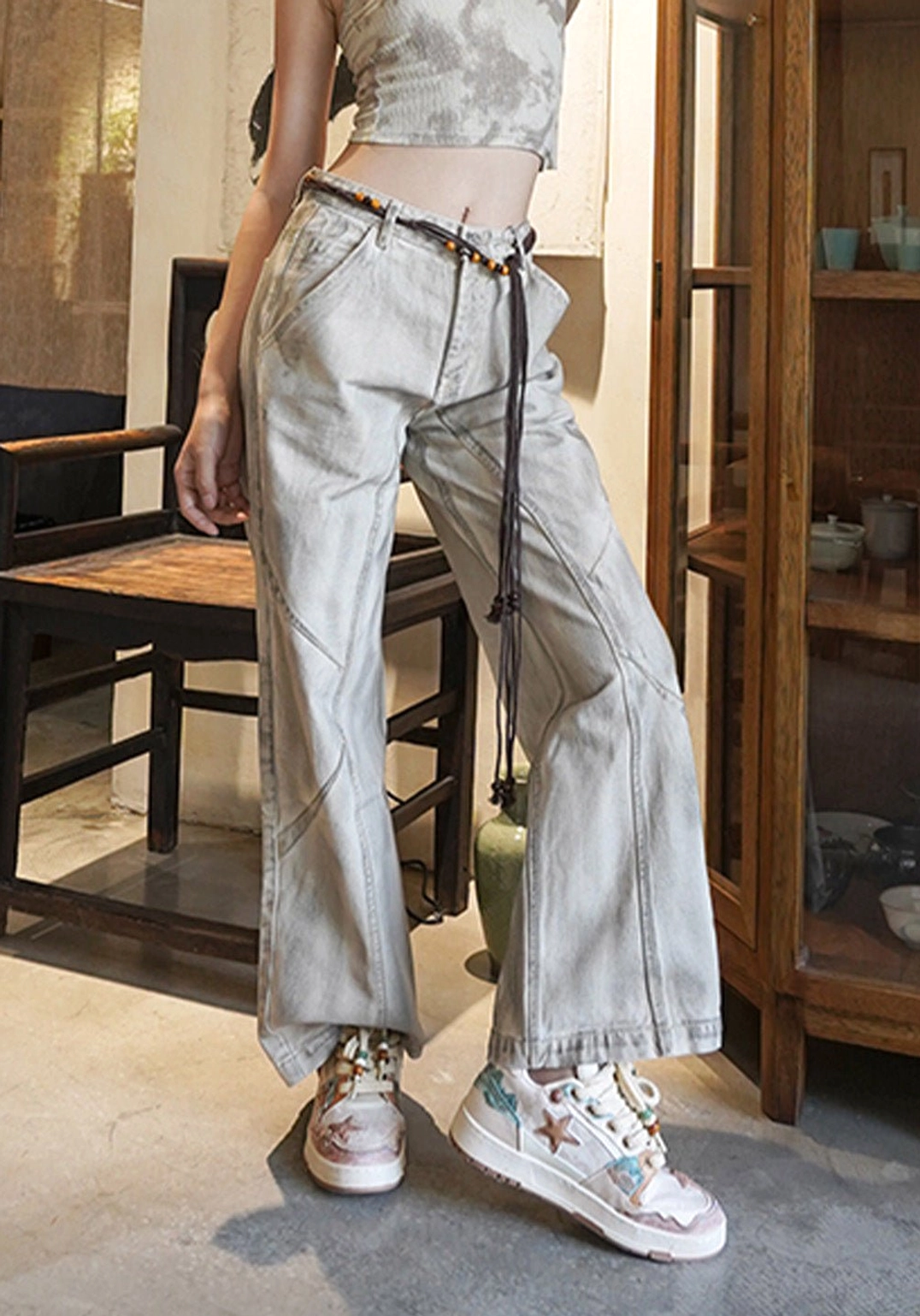 Full lower-body outfit featuring beige and brown star panel court sneakers with wide-leg pants and cropped top