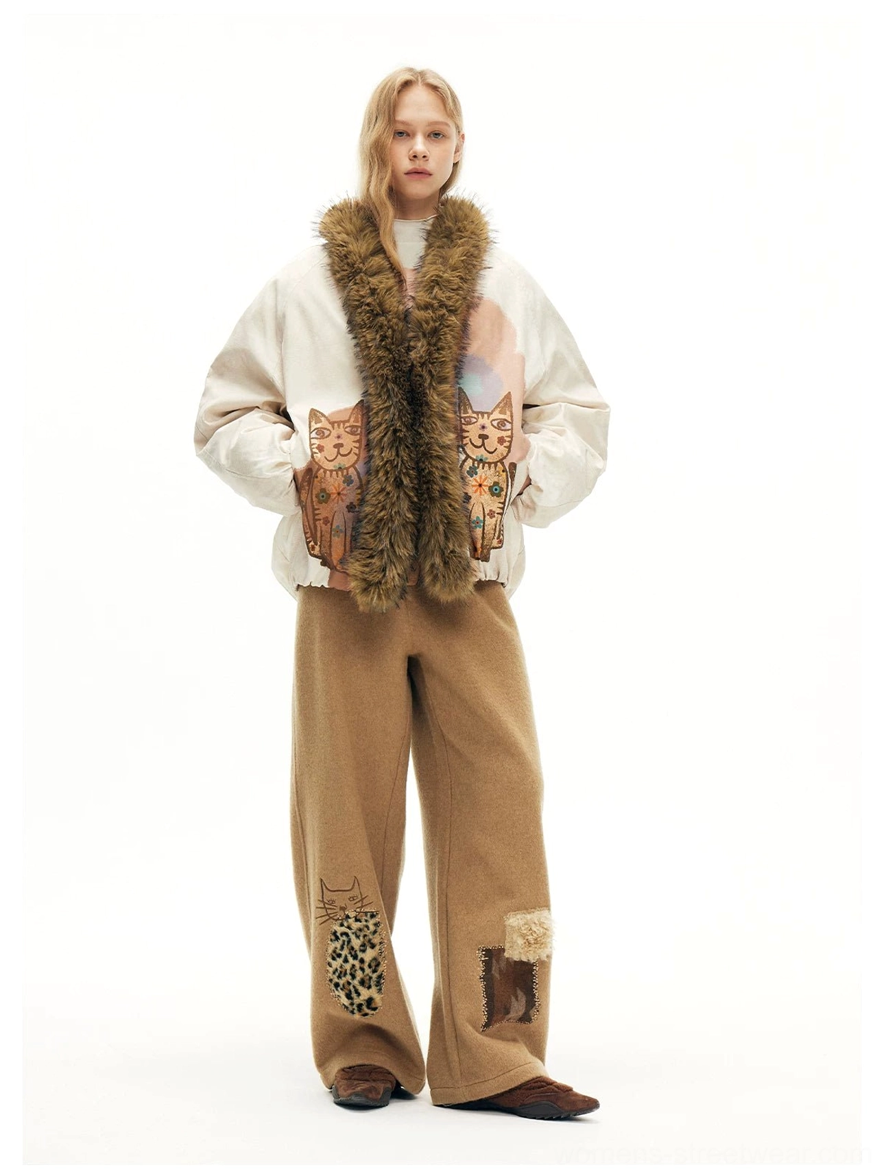 Beige cat graphic bomber jacket with hands in pockets and brown faux fur trim styled for Korean streetwear