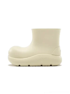 Beige chunky short rain boots in left side view with matte rubber upper rounded toe and thick platform sole