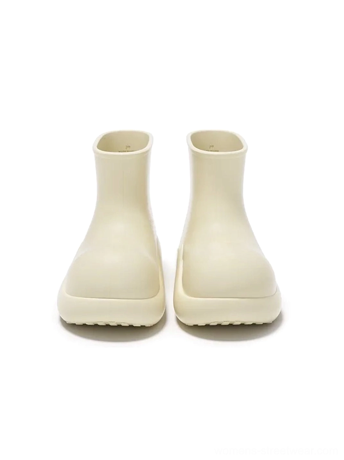 Front view of beige chunky short rain boots with rounded toe and creamy beige platform outsole