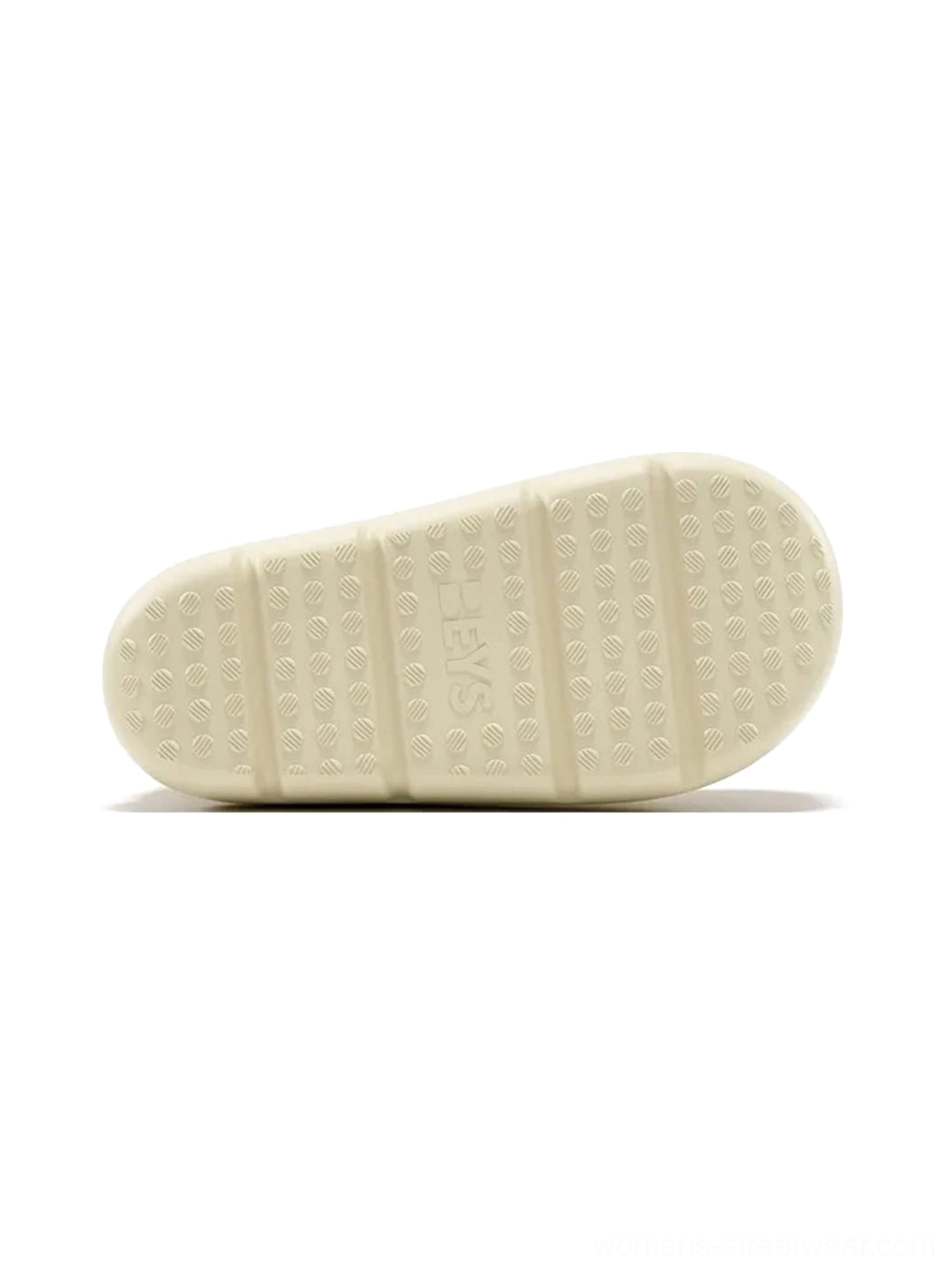 Textured non-slip rubber outsole of beige chunky short rain boots shown in top down product view