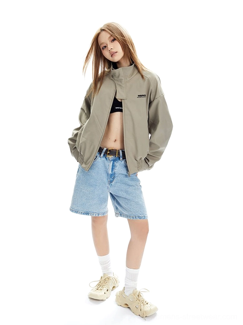 Back three-quarter view of a beige cropped bomber jacket with a high stand collar, relaxed sleeves, side pockets, and casual Y2K styling