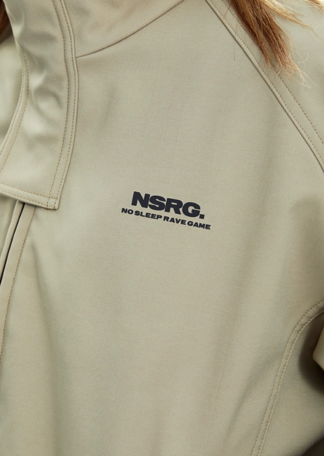 Close-up detail of beige matte woven fabric, high stand collar construction, chest graphic detail, and clean utility stitching