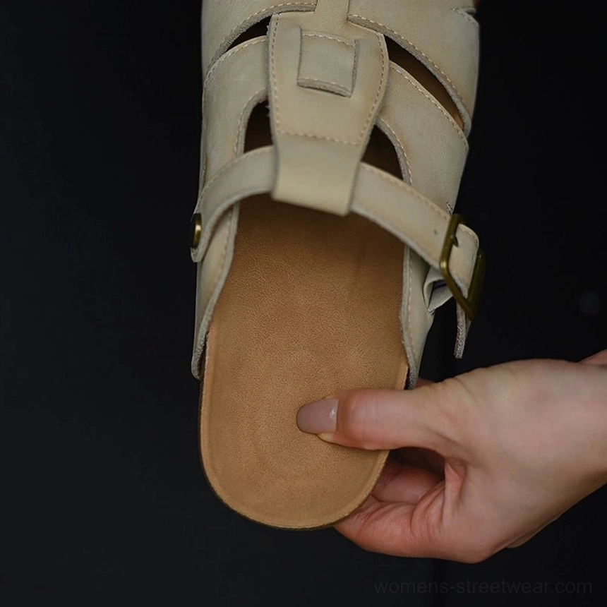 Interior view of beige fisherman sandals showing the soft cushioned footbed, layered cork-style midsole, woven leather upper, and gold-tone buckle hardware