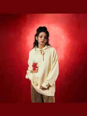 Beige floral flame oversized streetwear hoodie front view with red embroidered chest graphic
