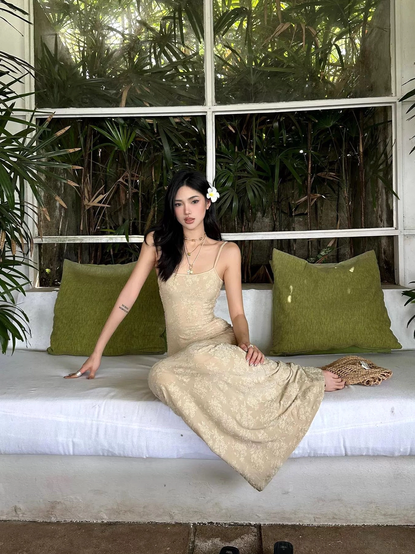 Beige floral lace mermaid maxi dress shown in a seated three-quarter view with fitted floor-length silhouette