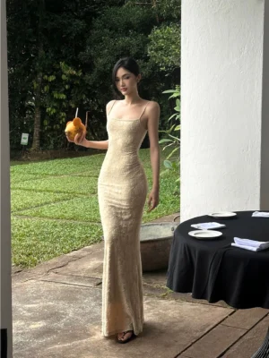Beige floral lace mermaid maxi dress with adjustable spaghetti straps and fitted fishtail silhouette shown from a full-body side perspective