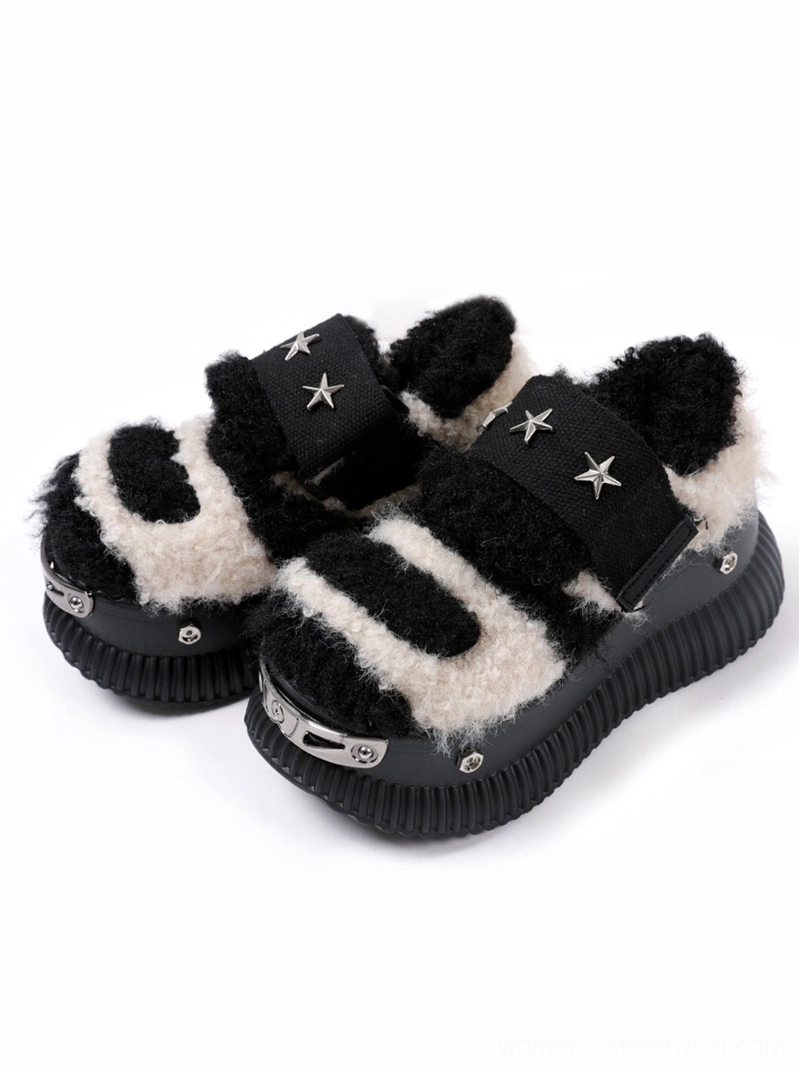 Side three-quarter view of beige fuzzy platform sneakers with black patchwork panels, silver star strap hardware, and metal toe caps