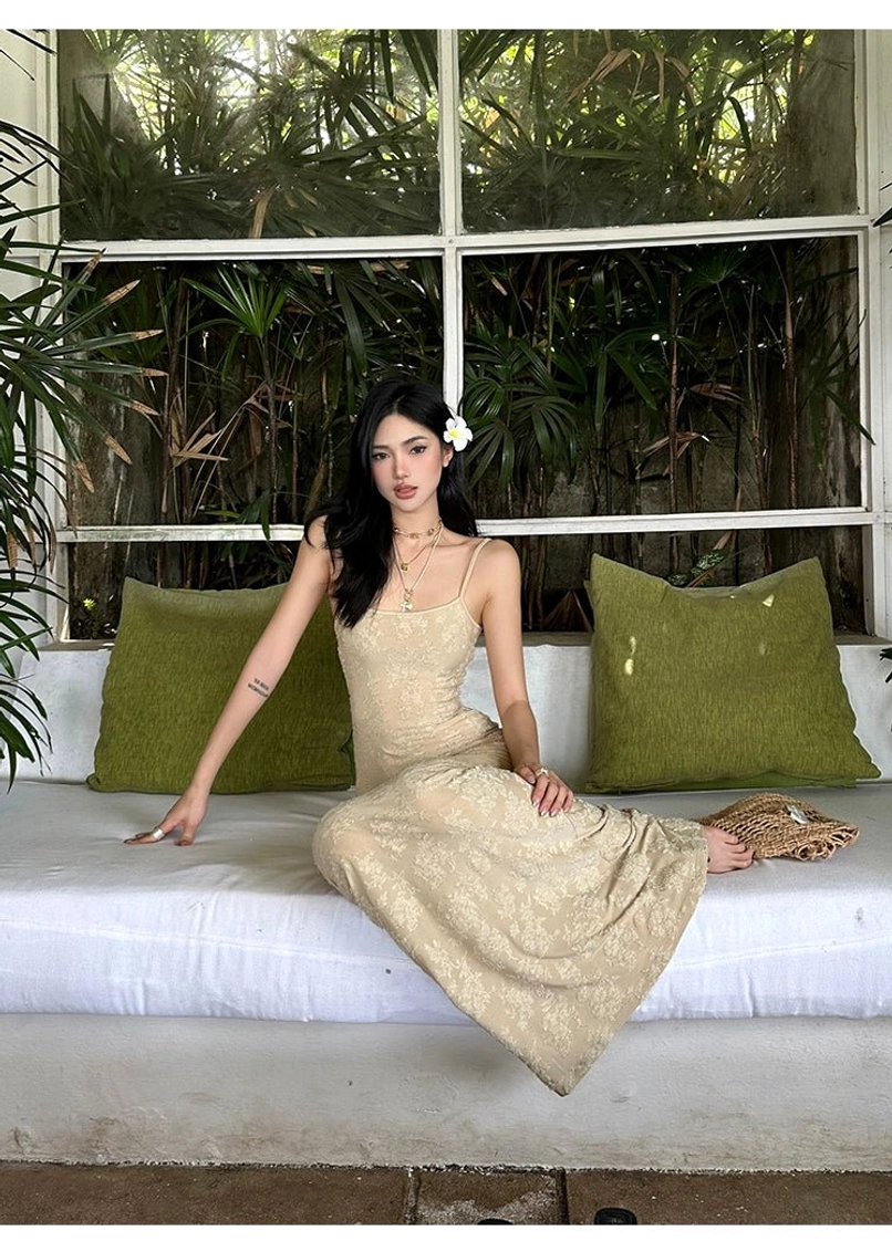 Beige lace mermaid maxi dress with floor-length fishtail hem and spaghetti straps shown in a seated front view