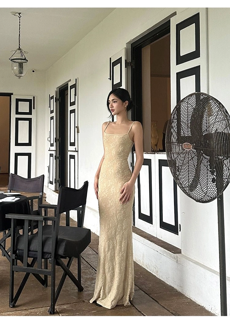 Beige lace slip dress with elongated floor-length profile fitted bodice and softly flared fishtail hem